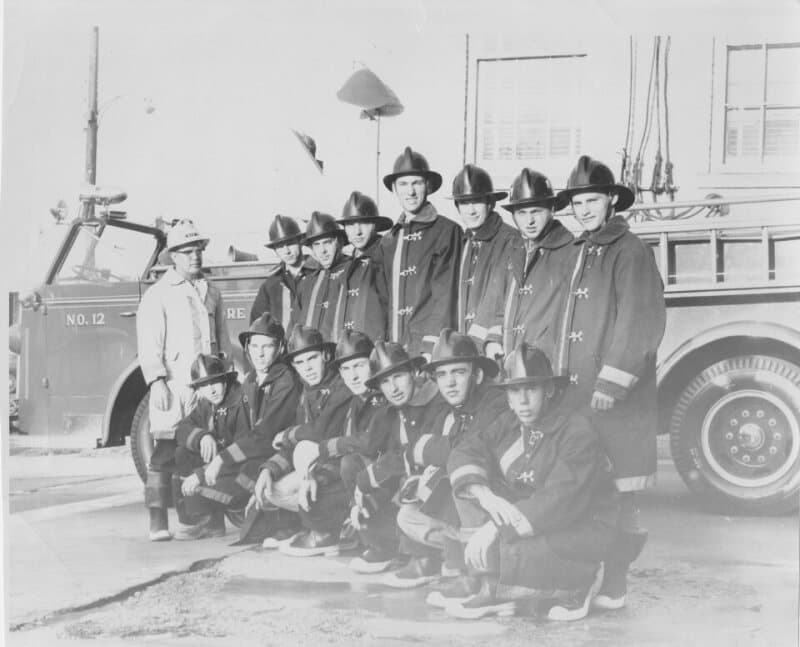 Denton Fire Chief Jack Gentry with the department's student firemen, in turnout coats and helmets, in front of Engine No. 12